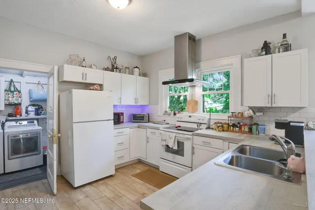 a kitchen with a sink cabinets and window
