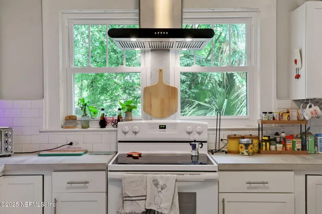 a kitchen with a sink stove and cabinets