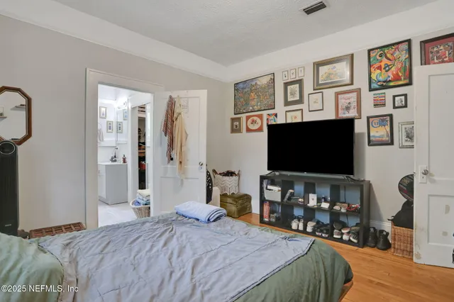 a bedroom with furniture and a flat screen tv