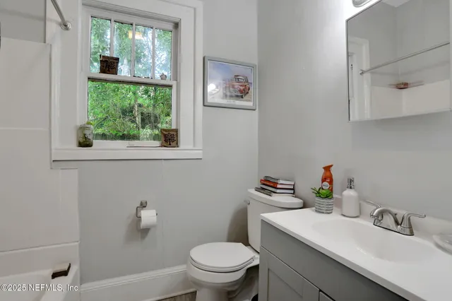 a bathroom with a shower and a window