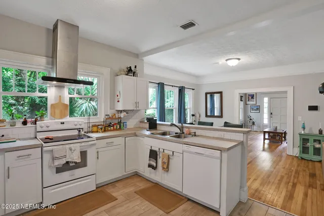 a kitchen with a sink stove and cabinets