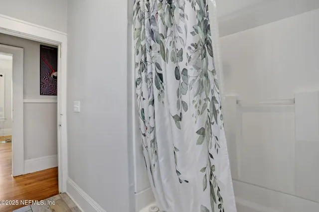 a bedroom with a bed and large windows