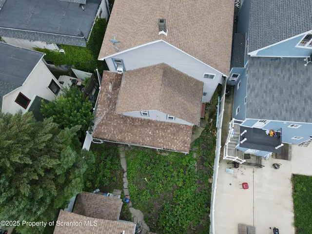 an aerial view of a house with a yard and a garage