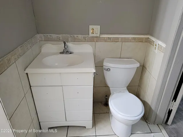 an empty room with wooden floor and a window