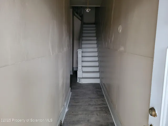 a spacious bathroom with a granite countertop sink a toilet and a mirror