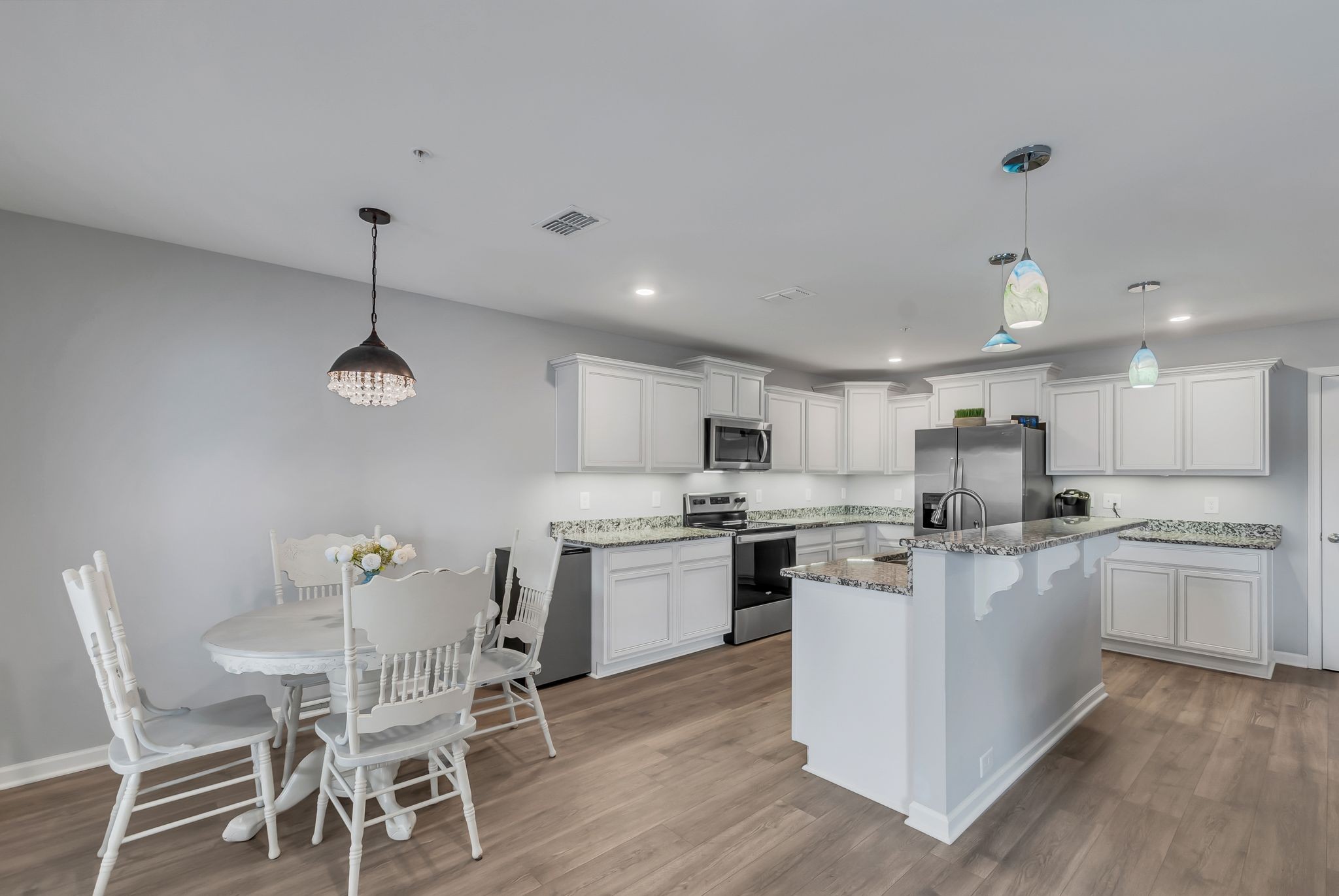 427 Tristan Way Spring Hill Spring Hill, TN 37174 - Photo 11 of 41 a kitchen with kitchen island a stove a table and chairs in it