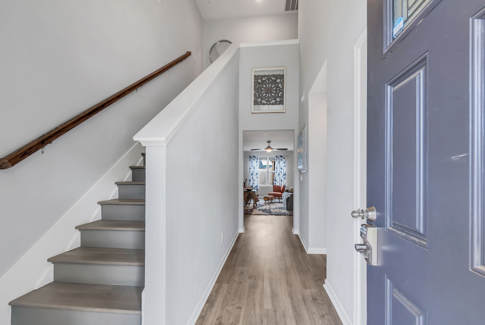 427 Tristan Way Spring Hill Spring Hill, TN 37174 - Photo 6 of 41 a view of a hallway with wooden floor and staircase