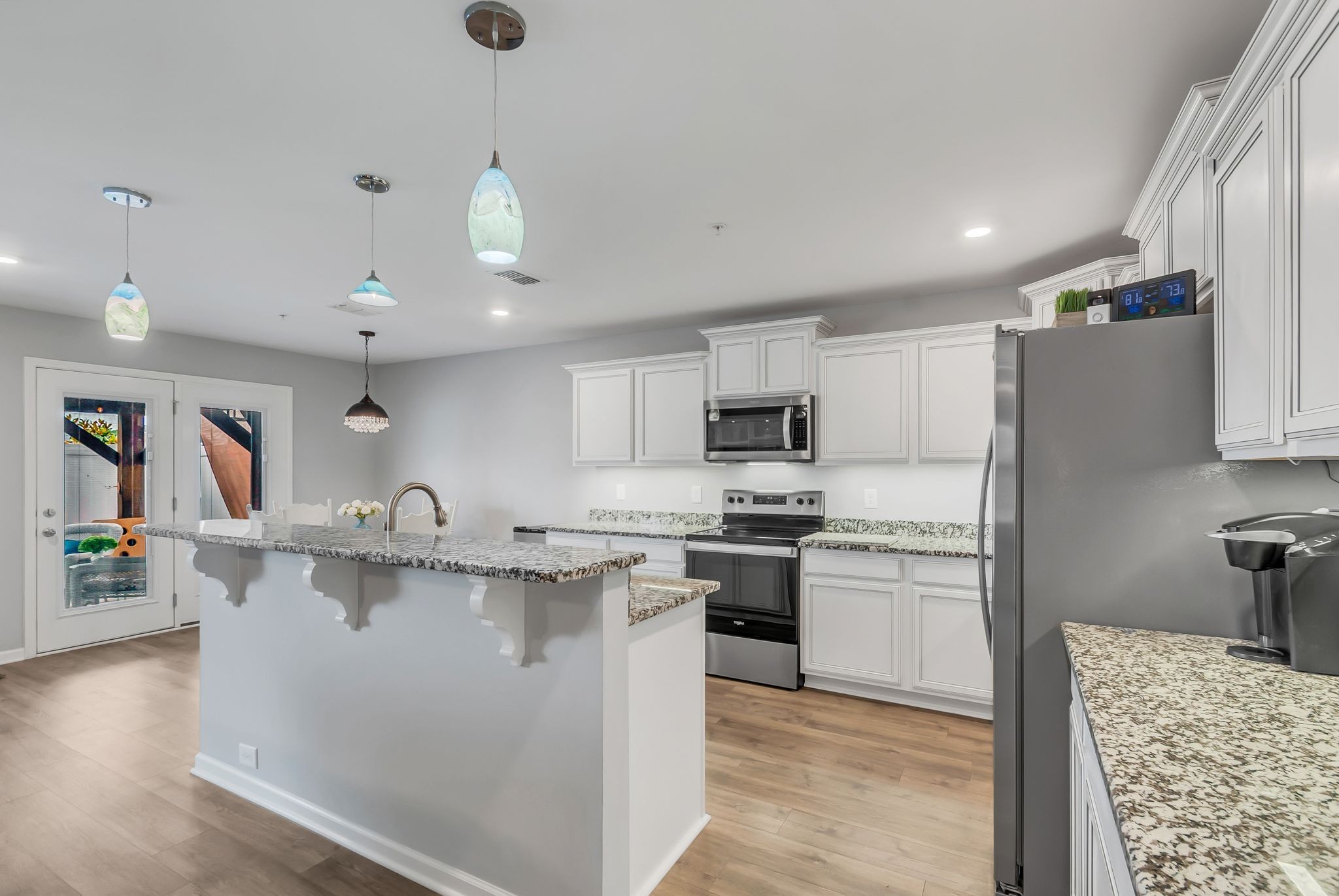 427 Tristan Way Spring Hill Spring Hill, TN 37174 - Photo 8 of 41 a kitchen with stainless steel appliances granite countertop a sink dishwasher a refrigerator and a stove with wooden floor
