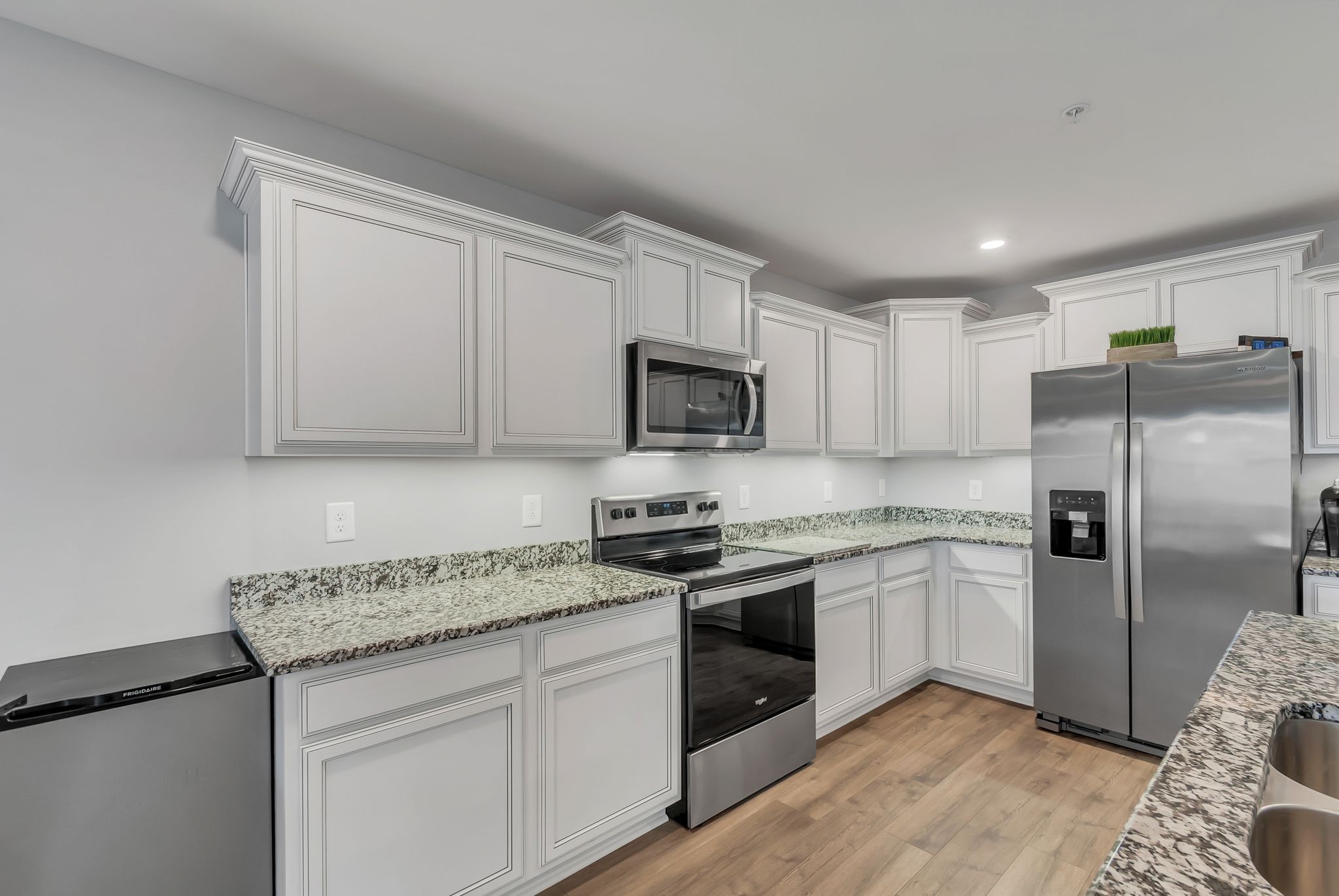 427 Tristan Way Spring Hill Spring Hill, TN 37174 - Photo 9 of 41 a kitchen with stainless steel appliances granite countertop a stove a sink and a refrigerator