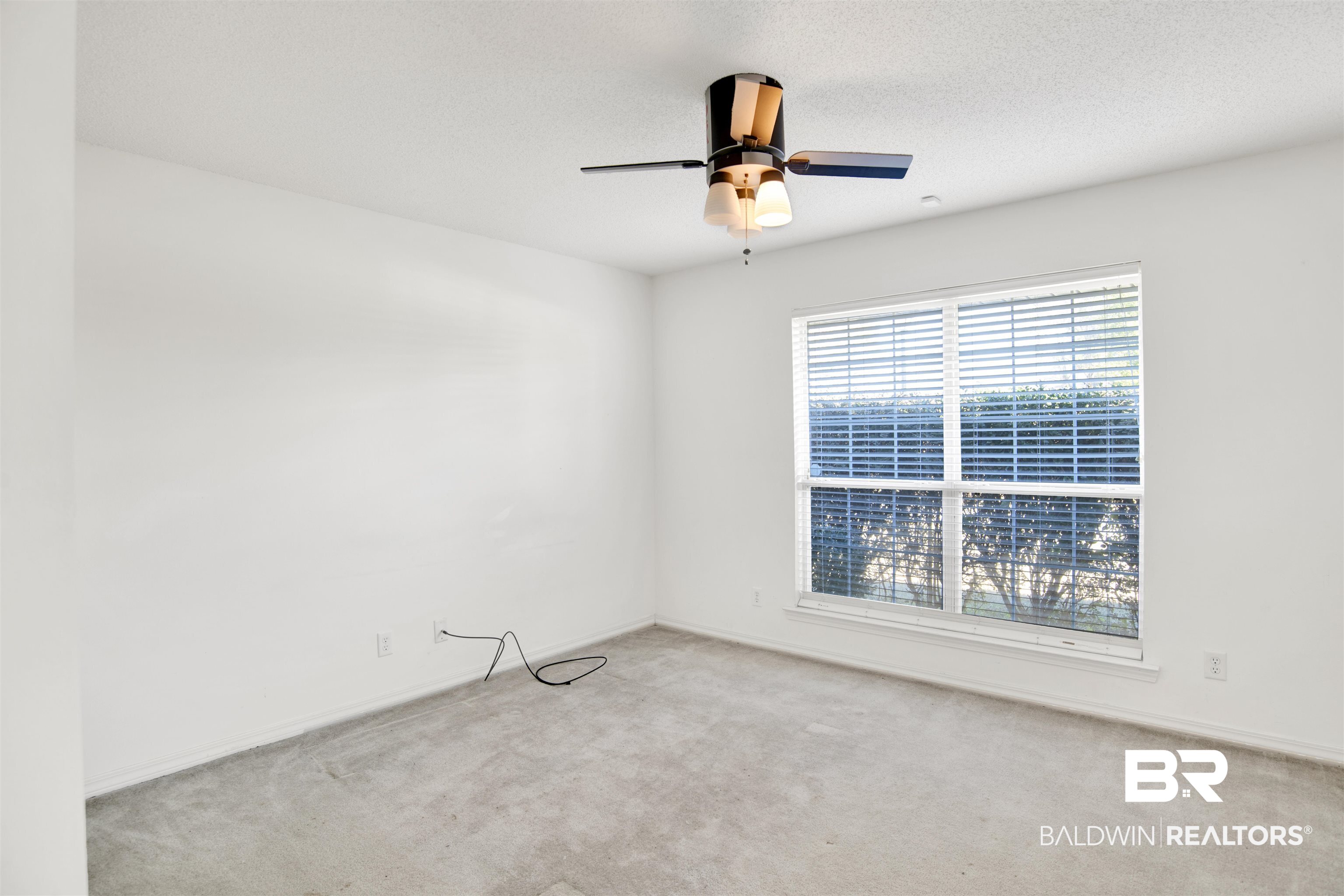 7297 Bridgemill Drive Mobile, AL 36619 - Photo 18 of 33 Spare room featuring carpet, a ceiling fan, and a textured ceiling