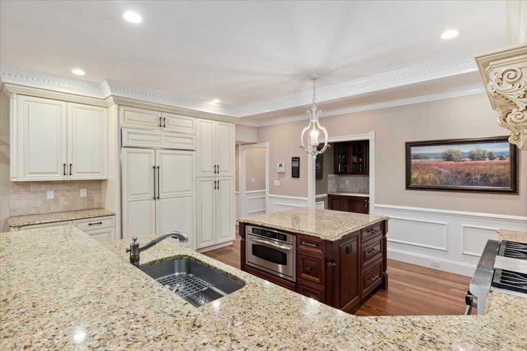 56 Mill Brook Avenue Walpole, MA 02081 - Photo 11 of 42 a living room with stainless steel appliances kitchen island granite countertop a refrigerator and a sink