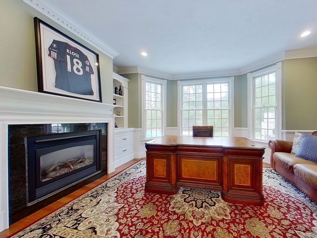 56 Mill Brook Avenue Walpole, MA 02081 - Photo 18 of 42 a living room with furniture and a fireplace