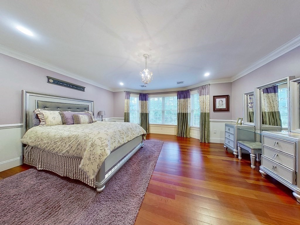 56 Mill Brook Avenue Walpole, MA 02081 - Photo 23 of 42 a bedroom with a large bed and a wooden floor