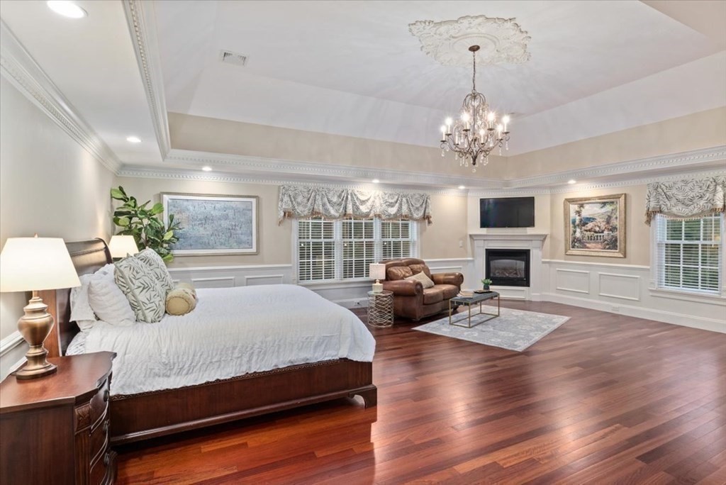 56 Mill Brook Avenue Walpole, MA 02081 - Photo 26 of 42 a bedroom with a bed wooden floor and a fireplace