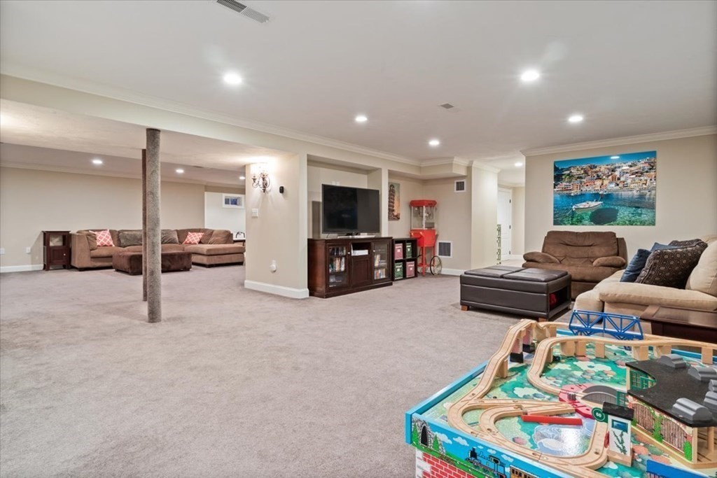 56 Mill Brook Avenue Walpole, MA 02081 - Photo 30 of 42 a living room with furniture and a flat screen tv