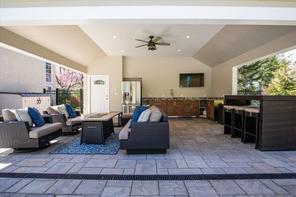 56 Mill Brook Avenue Walpole, MA 02081 - Photo 38 of 42 a living room with furniture and a flat screen tv