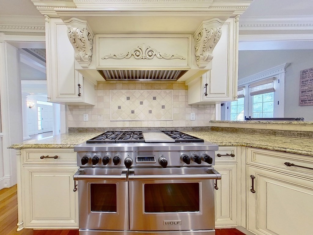 56 Mill Brook Avenue Walpole, MA 02081 - Photo 9 of 42 a kitchen with a stove and white cabinets