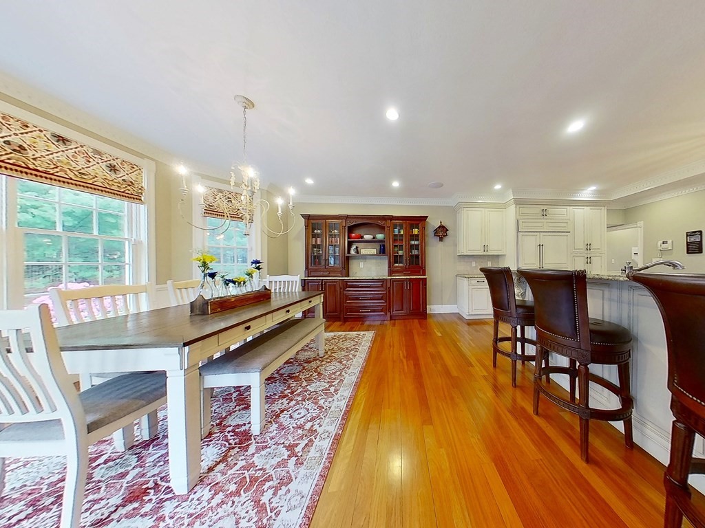 56 Mill Brook Avenue Walpole, MA 02081 - Photo 10 of 42 a dining hall with stainless steel appliances granite countertop a dining table and chairs with wooden floor