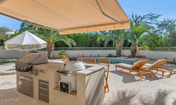 a front view of a house with swimming pool having outdoor seating