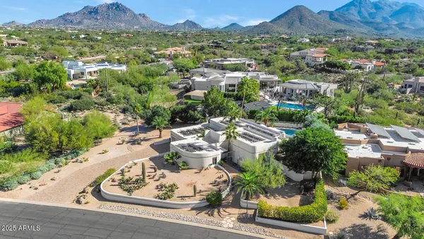 an aerial view of a swimming pool with mountain view