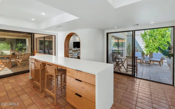 a kitchen with counter top space and living room