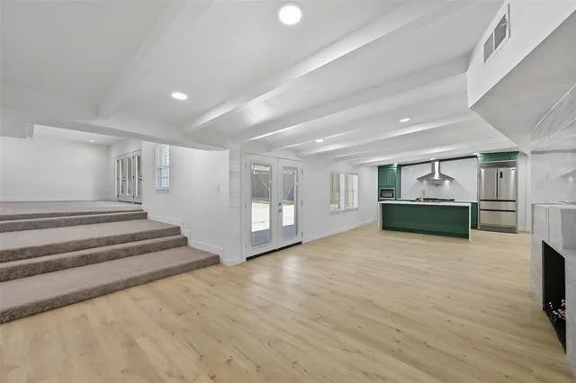 a view of an empty room with a fireplace and cabinet