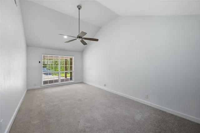 a view of a room with a ceiling fan and a window