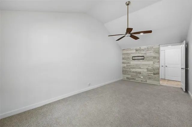 a view of an empty room with a ceiling fan