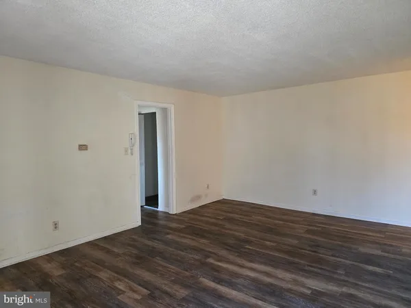 a view of an empty room and wooden floor