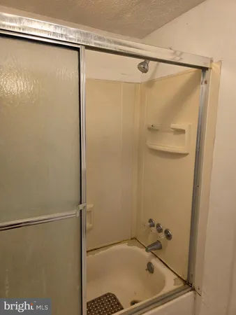 a bathroom with a shower and a glass door