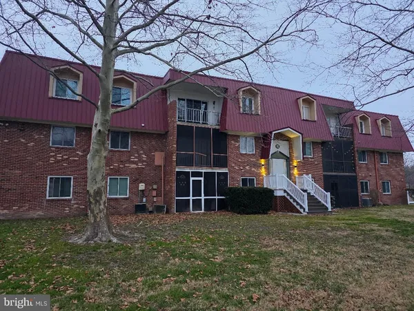 a front view of a building with a yard