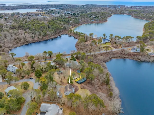 an aerial view of a houses with a lake view