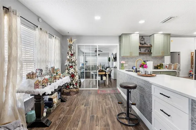 a kitchen with sink cabinets and wooden floor