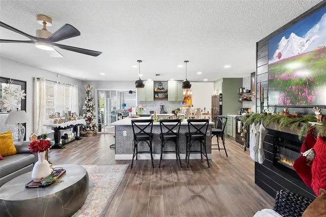 a living room with lots of furniture and kitchen view