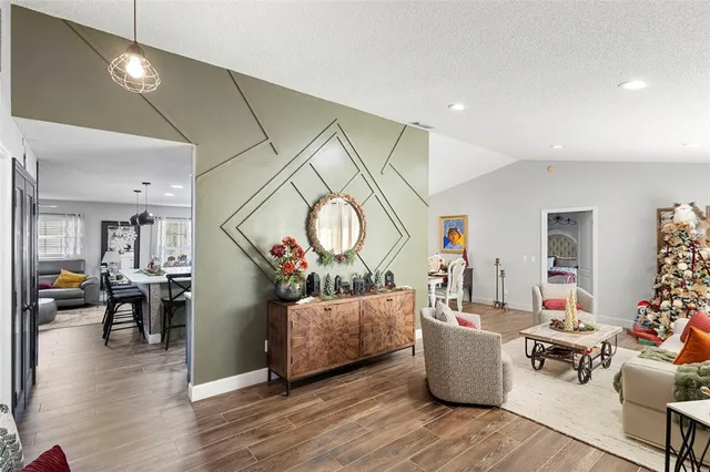 a living room with fireplace furniture and a wooden floor