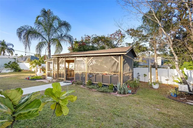 a view of a backyard with plants and a patio
