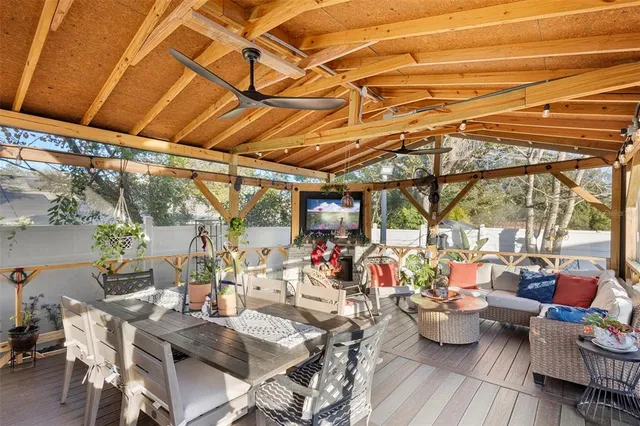 a view of a patio with dining table and chairs