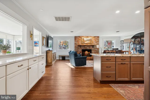 a large kitchen with stainless steel appliances kitchen island granite countertop a large counter top space a sink and cabinets