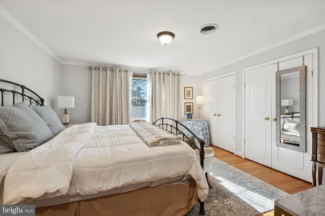 a bedroom with a bed and a refrigerator