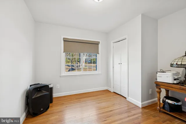 a view of an empty room and wooden floor