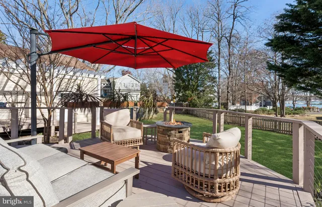a view of a patio with couches and table under an umbrella