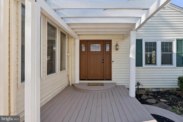a view of a house with a wooden deck