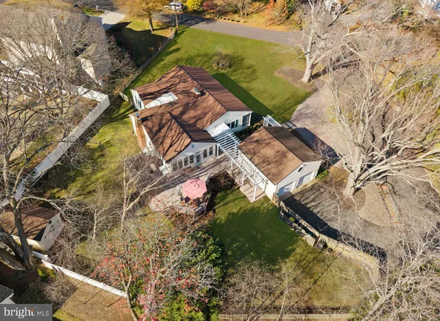 an aerial view of house with yard and mountain view in back