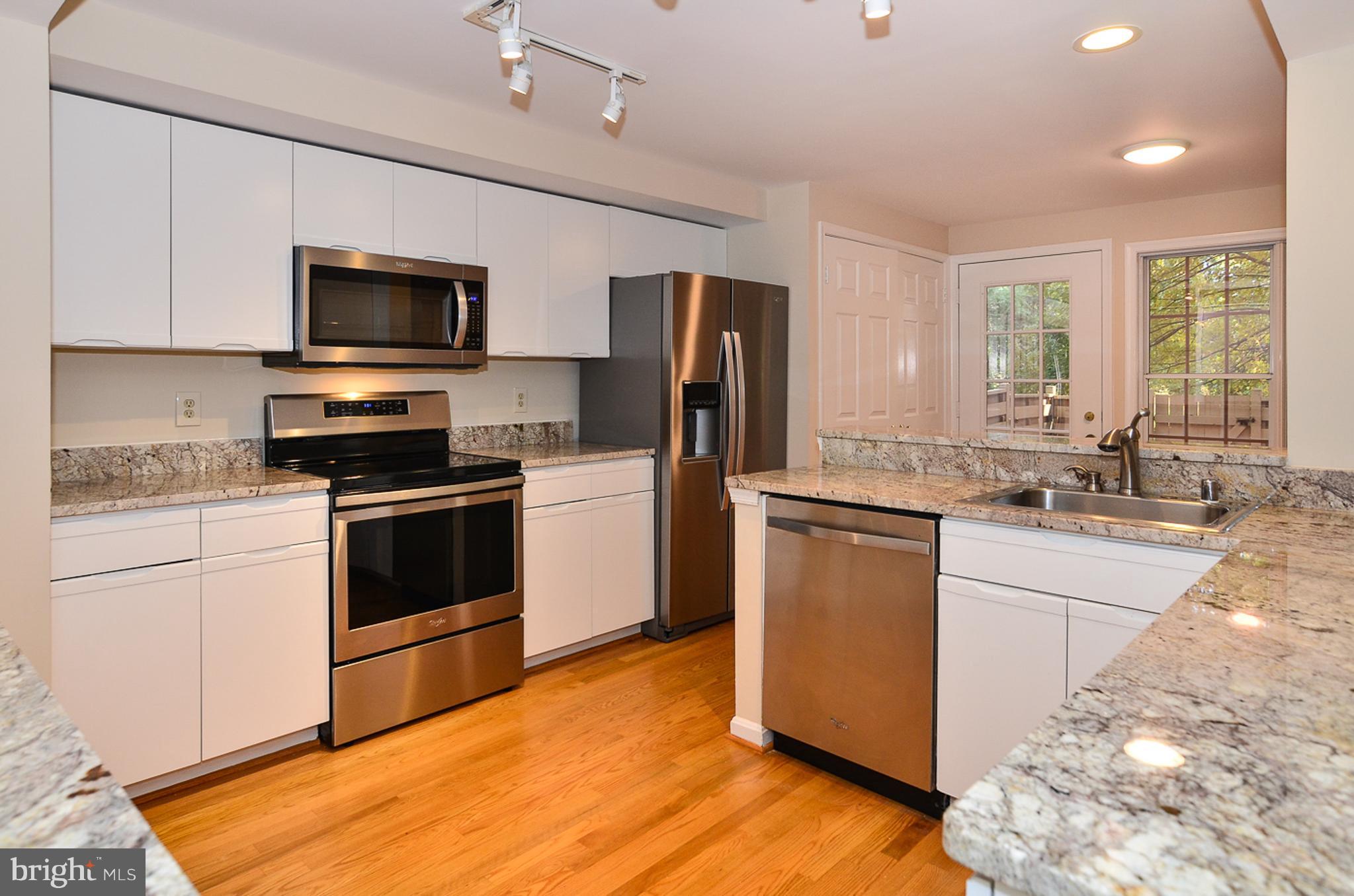 1558 Deer Point Way Reston, VA 20194 - Photo 9 of 22 a kitchen with granite countertop a refrigerator stove and sink