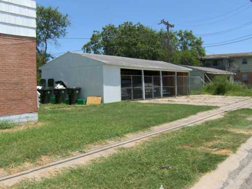 653 Robinson Street, Unit 1 Corpus Christi, TX 78404 - Photo 4 of 4 a front view of a house with a yard and trees