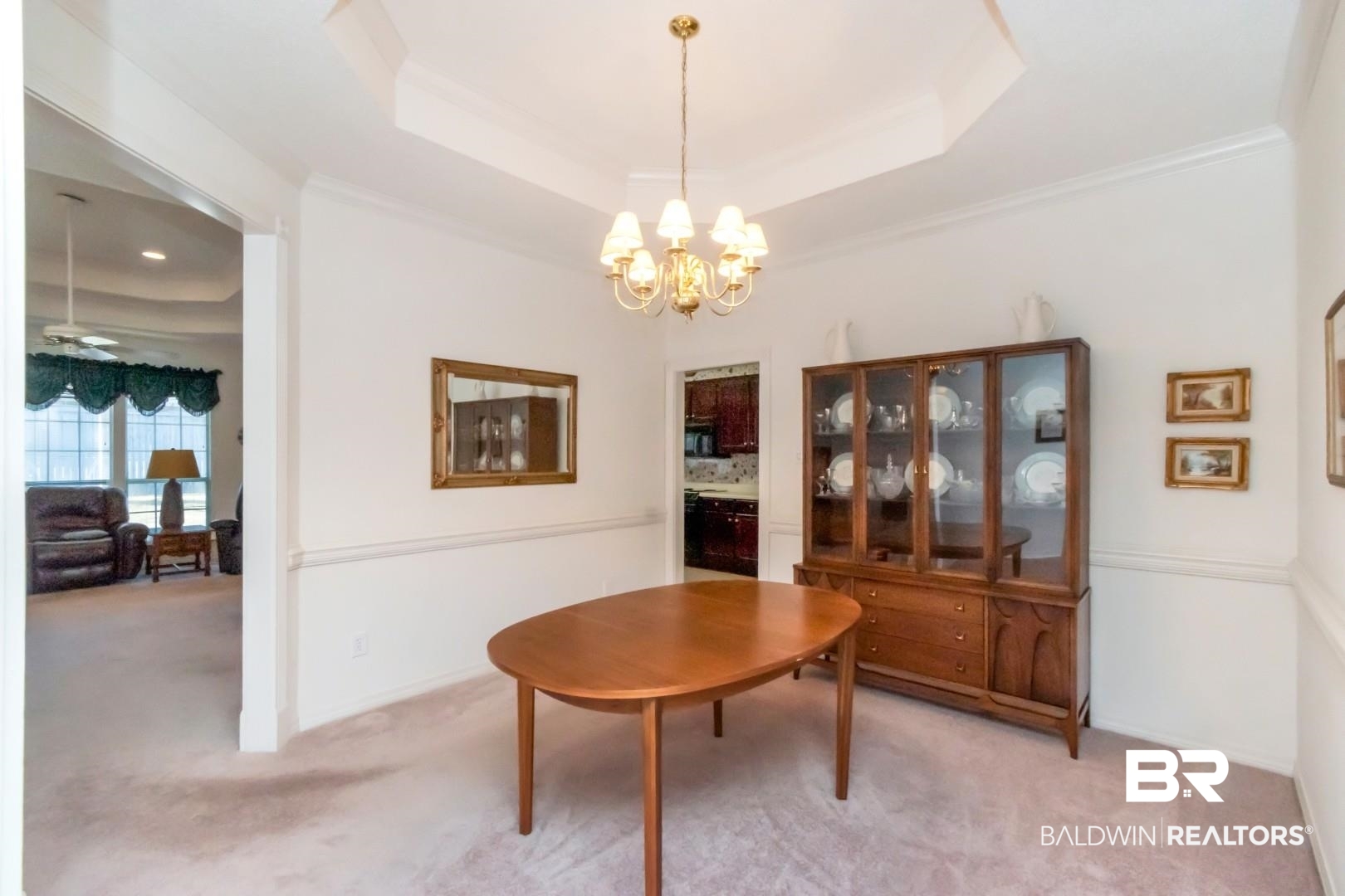 1032 Cross Gates Place Mobile, AL 36609 - Photo 4 of 34 Carpeted dining area with a raised ceiling, a chandelier, a ceiling fan, and ornamental molding