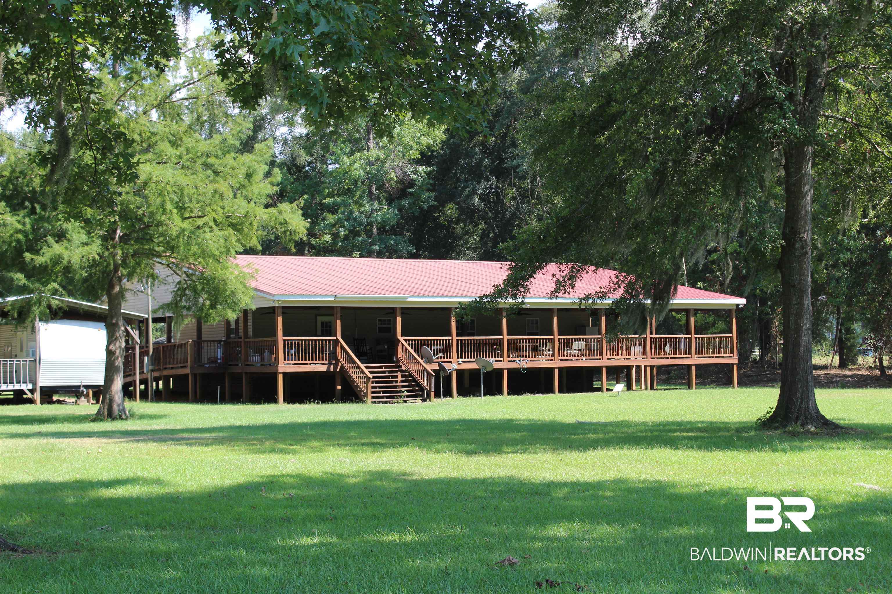 7258 Henderson Road Lowndesboro, AL 36752 - Photo 22 of 22 Rear view of property with a metal roof and a yard
