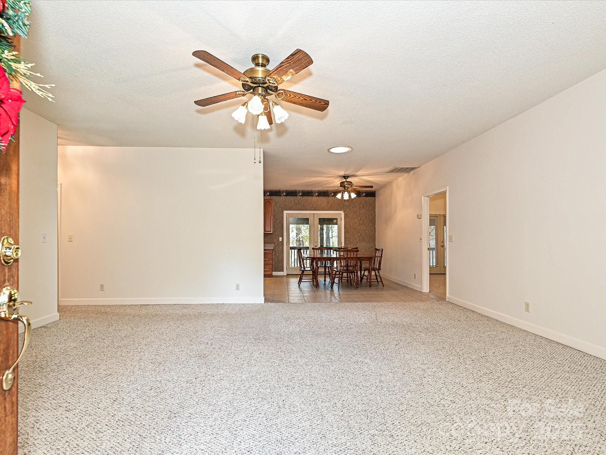 25040 Timberlake Drive Tega Cay, SC 29708 - Photo 6 of 40 an empty room with windows and fan