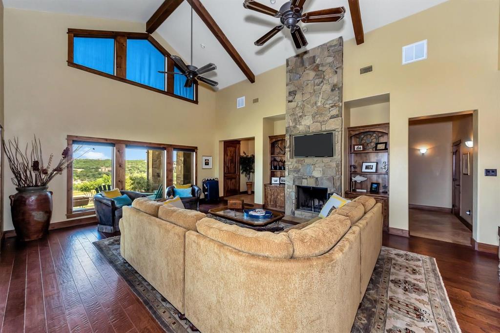 1231 Rawhide Ridge Graford, TX 76449 - Photo 15 of 26 Living room with a fireplace, beam ceiling, dark hardwood / wood-style floors, and high vaulted ceiling