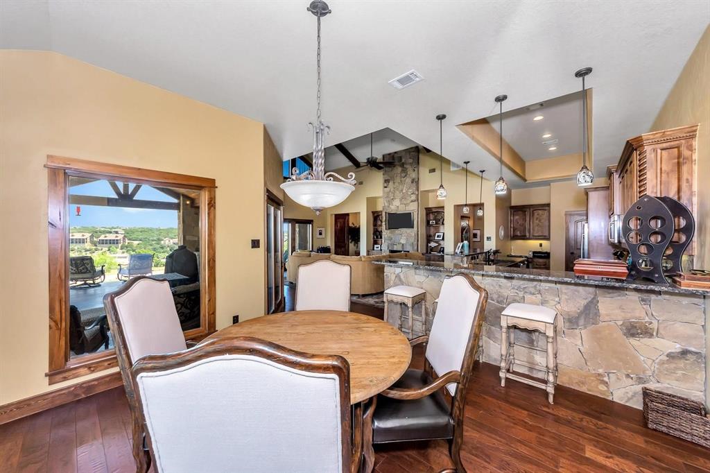 1231 Rawhide Ridge Graford, TX 76449 - Photo 18 of 26 Dining room featuring lofted ceiling and dark wood-type flooring